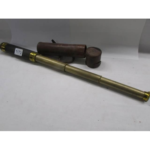 1173 - A leather cased four draw brass telescope.