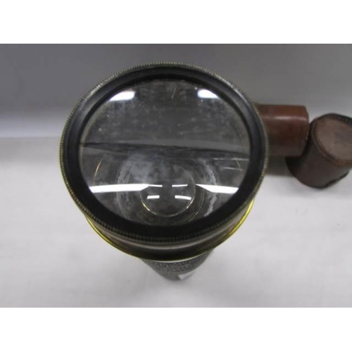 1173 - A leather cased four draw brass telescope.