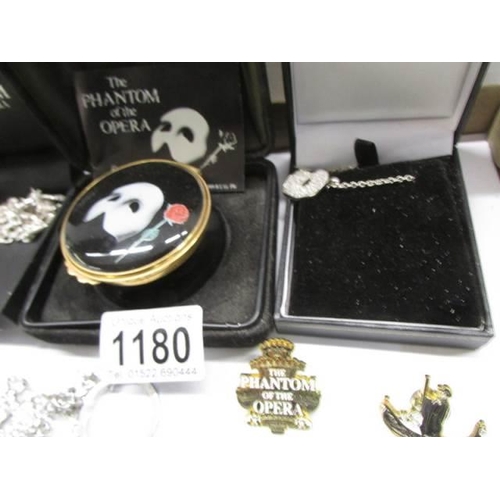 1180 - A silver Phantom mask necklace, enamel box, charm bracelet, pin badges etc.,