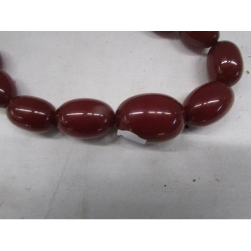 1182 - An amber coloured necklace. (64.47grams)