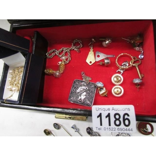 1186 - A box of costume jewellery including hat pins, silver & pearl earrings etc.,