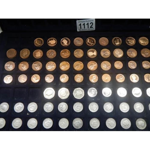 1112 - Four trays of assorted coins.