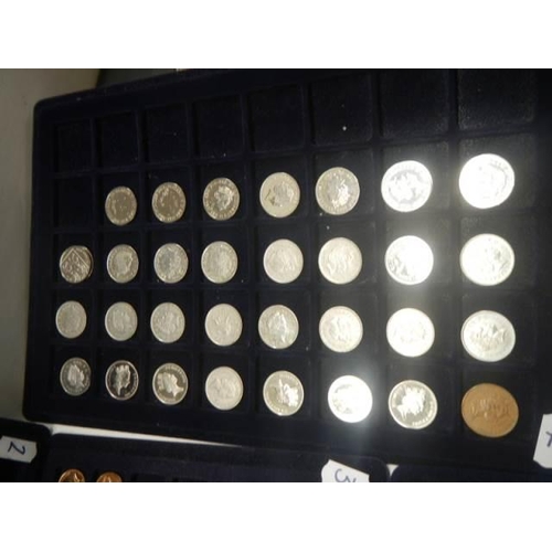 1112 - Four trays of assorted coins.