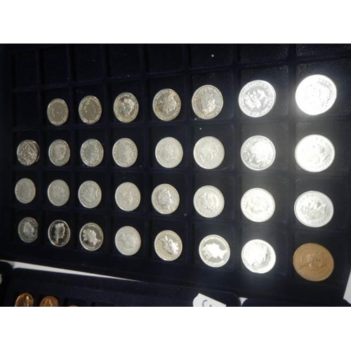 1112 - Four trays of assorted coins.