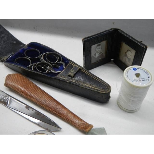 1156 - A good lot of needlework items including tape measures, scissors etc.,