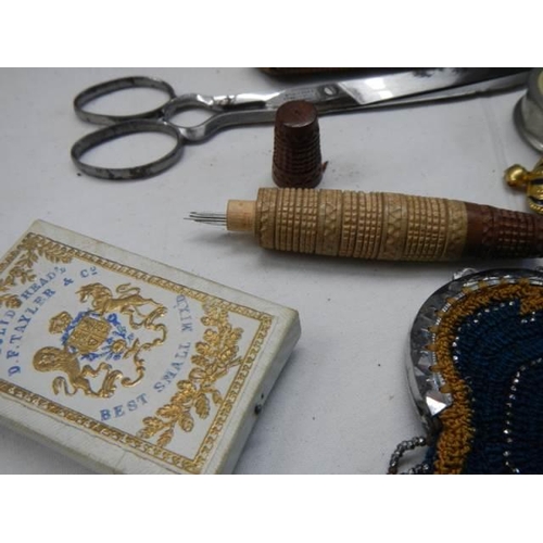 1156 - A good lot of needlework items including tape measures, scissors etc.,