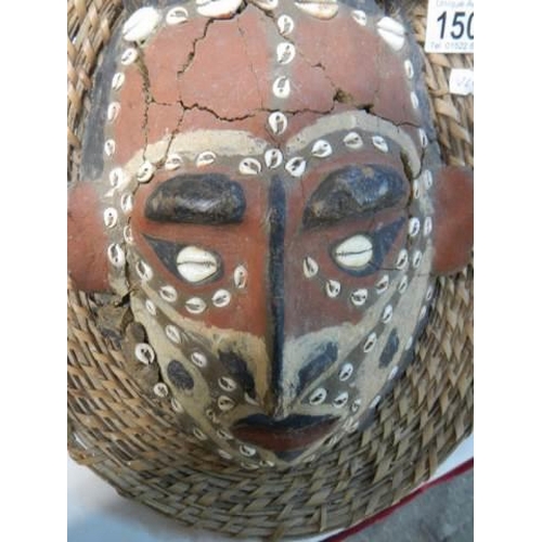 1503 - An unusual Tribal Mask of terracotta in a wooden frame the back of which is the shell of a tortoise.