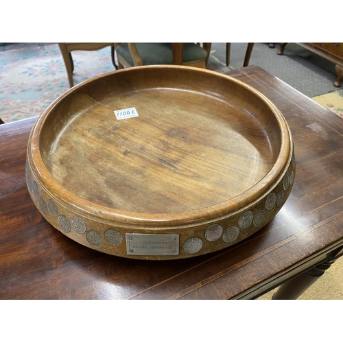 A large teak fruit bowl inlaid with sixpences in numerical order from ...