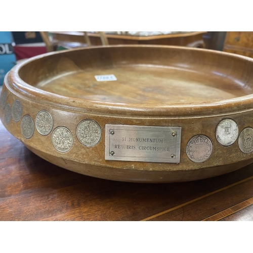 1100E - A large teak fruit bowl inlaid with sixpences in numerical order from 1909-1964 along with Latin ins... 