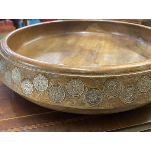 1100E - A large teak fruit bowl inlaid with sixpences in numerical order from 1909-1964 along with Latin ins... 