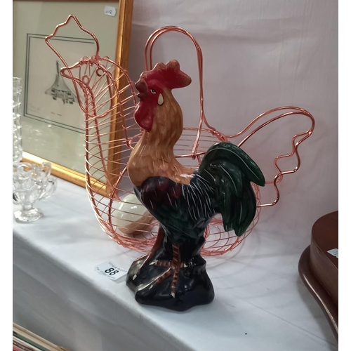 88 - A copper coloured chicken egg basket with marble egg and a cockerel figure