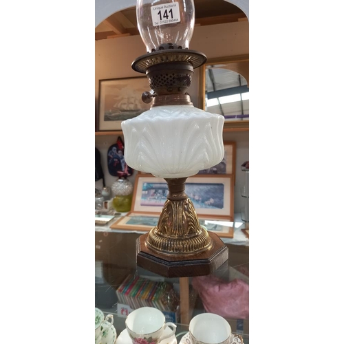 141 - An oil lamp with white glass font