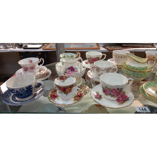 144 - A good selection of china cups and saucers plus trios, including Royal Albert etc