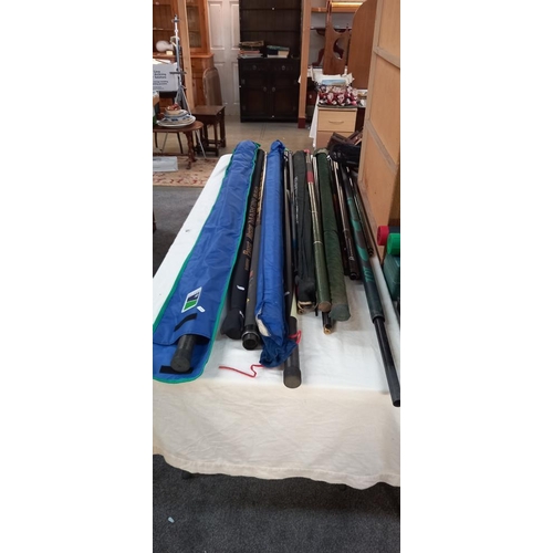 164 - A large lot of fishing rods, empty rod holders, new large net, tackle box etc COLLECT ONLY