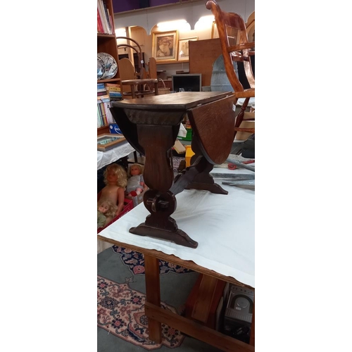 183 - An oak table with drop sides and rotating top, COLLECT ONLY