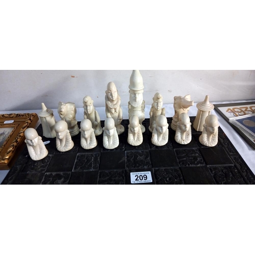 209 - A polished stone African chess set on a chess board (2 pieces a/f, some smaller ones have nibbles)