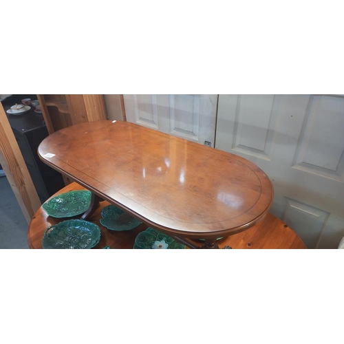 303 - An oval dark wood coffee table COLLECT ONLY