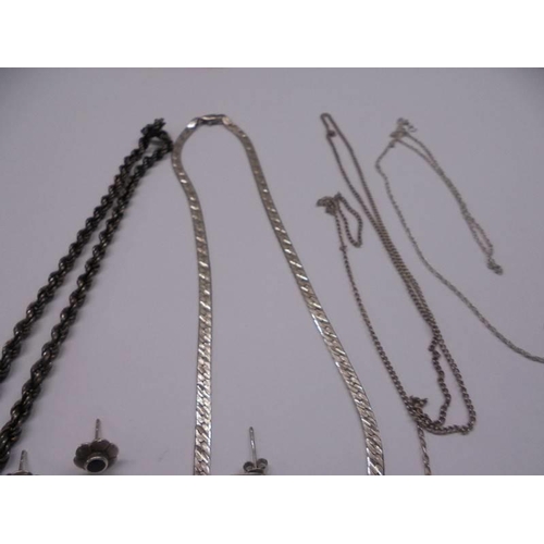 1001 - A mixed lot of silver items including necklaces, chains, charms etc.,