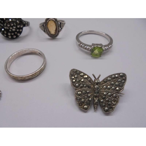 1002 - A silver butterfly brooch, five silver rings, silver pendant and silver threepenny bit.