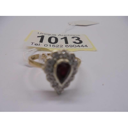 1013 - A yellow gold pear shaped ruby and diamond ring, size N, 2.6 grams.