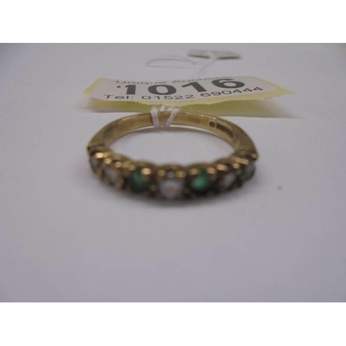 1016 - An 18ct gold diamond and emerald ring, size N, 2.1 grams.