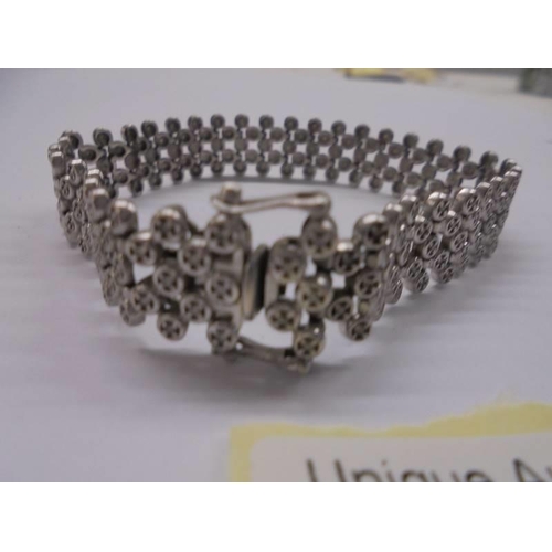 1020 - A diamond bracelet with approximately 200 small diamonds set in sterling silver, 18 grams.