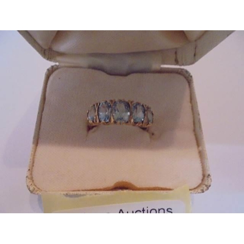 1029 - A five stone ring set with five rich blue topaz's in 9ct gold, size P, 3 grams.