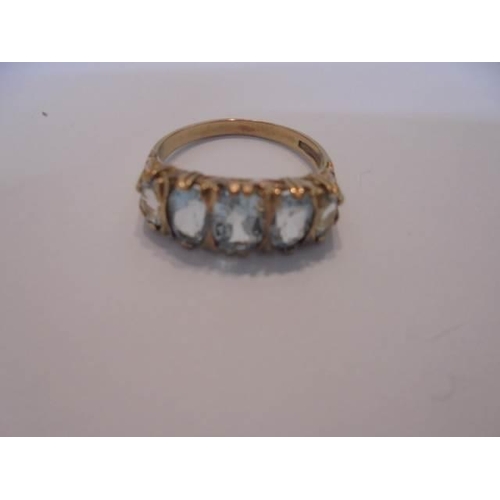 1029 - A five stone ring set with five rich blue topaz's in 9ct gold, size P, 3 grams.