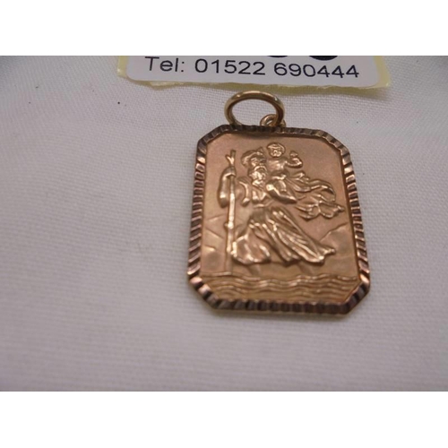 1053 - A 9ct gold St. Christopher pendant, 5.72 grams.