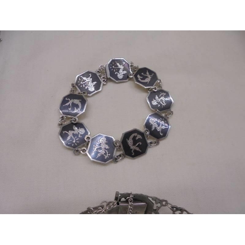 1062 - A good lot of silver bracelets, pendant etc.,