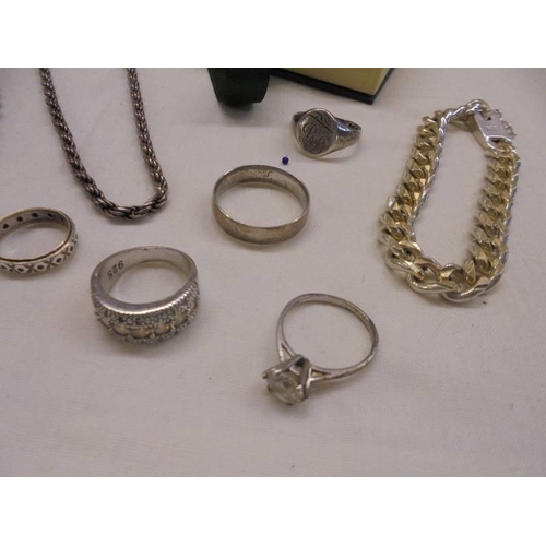 1077 - Three silver chains, five silver rings and a silver crucifix, 4 ounces.