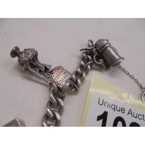 1097 - A silver charm bracelet with mainly silver charms.