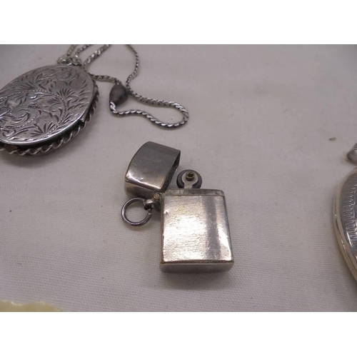 1101 - A silver locket, two white metal lockets and a miniature cigarette lighter.