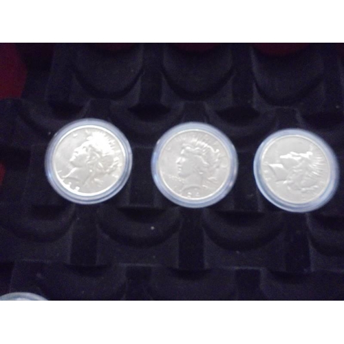 1122 - A collection of ten Morgan silver dollars in case, 1879, 1882, 1891, 1899, 1921 - 1926.