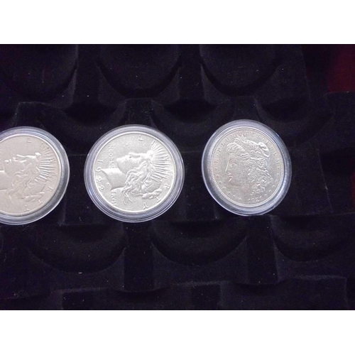 1122 - A collection of ten Morgan silver dollars in case, 1879, 1882, 1891, 1899, 1921 - 1926.