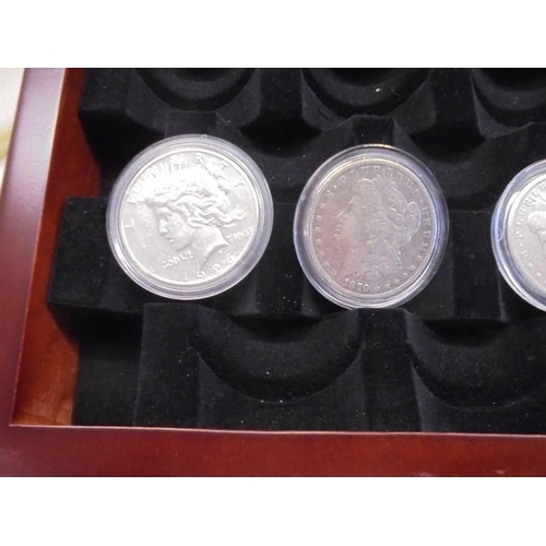 1122 - A collection of ten Morgan silver dollars in case, 1879, 1882, 1891, 1899, 1921 - 1926.