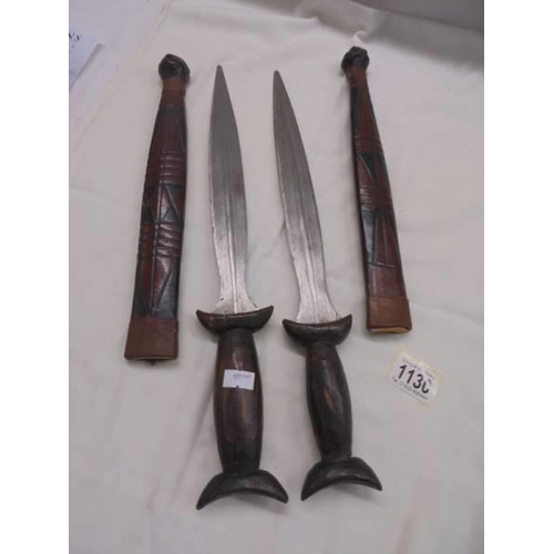 1130 - Two vintage (African Tribal?) daggers in sheaths.