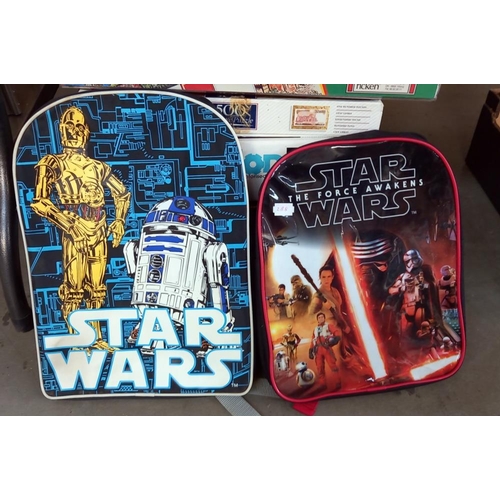 2473 - A quantity of jigsaws, games & 2 Star Wars backpacks