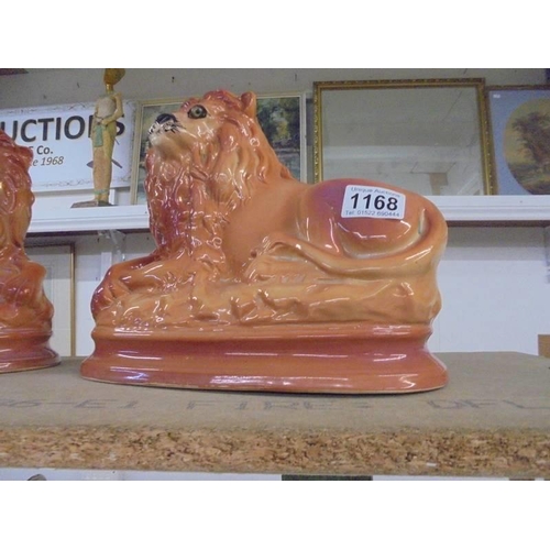 1168 - A pair of large Staffordshire reclining lions.