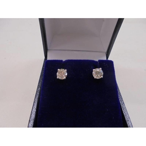 1193 - Pair of 18ct white gold 4-claw round brilliant cut solitaire diamond studs, boxed. Diamonds 1.04ct