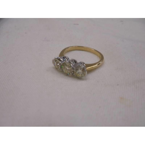 1194 - Certificated 18ct white and yellow gold diamond trilogy ring. RBC diamonds 1.26ct. Cert no. WGI96241... 