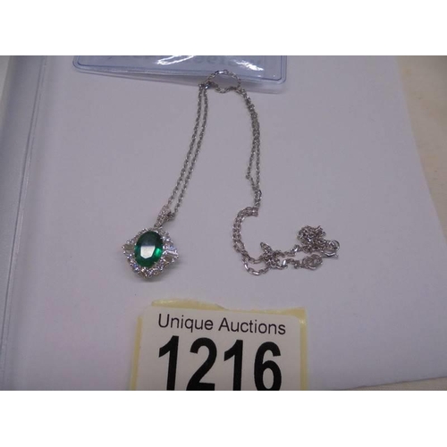 1216 - Certificated 18ct white gold pendant set with oval-cut emerald and a halo of RBC and tapered baguett... 