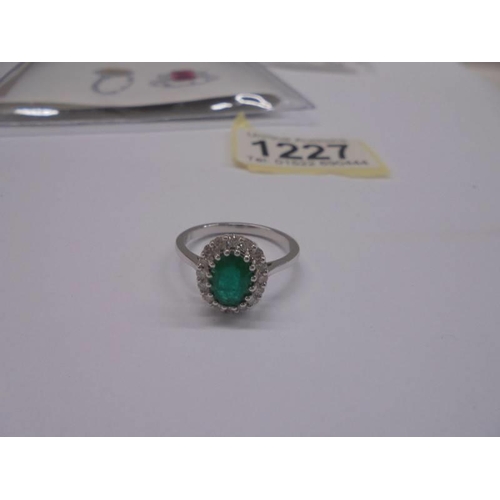 1227 - Certificated 18ct white gold emerald and diamond cluster ring. Oval-cut emerald 1.18ct. RBC diamonds... 