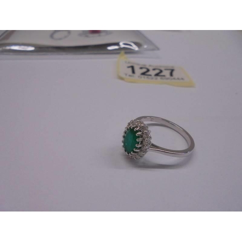 1227 - Certificated 18ct white gold emerald and diamond cluster ring. Oval-cut emerald 1.18ct. RBC diamonds... 