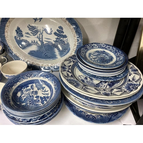 419 - selection of blue and white crockery Cups saucers plates bowls some willow pattern and others