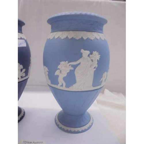 1265 - Two Wedgwood Jasper ware vases, one in dark blue and the other in pale blue.