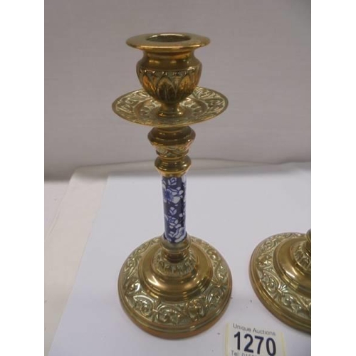 1270 - A pair of Victorian brass candlesticks with blue and white ceramic columns.