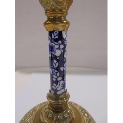 1270 - A pair of Victorian brass candlesticks with blue and white ceramic columns.