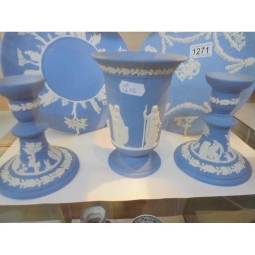 1271 - Five pieces of Wedgwood Jasper ware including a pair of candlesticks, plates etc.,