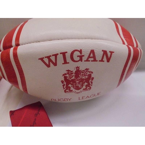 1302 - A signed Aston Villa 1990/01 season football, A signed Wigan Rugby league ball and a Wigan tie.